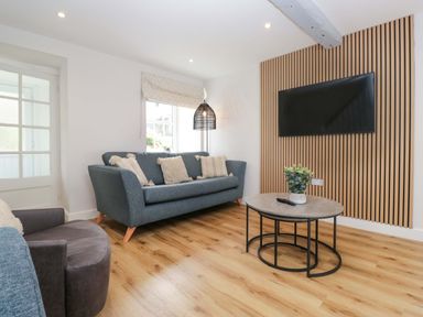 A living room with a sofa and coffee table at Riverside Cottage No 4, Keswick