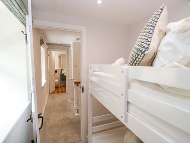 A bunk bed with pillows in a bedroom at Riverside Cottage No 4 in Keswick