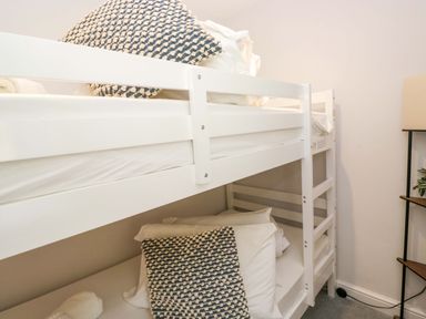 A bunk bed with pillows and towels at Riverside Cottage No 4 in Keswick