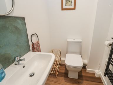 A bathroom with a wash basin and toilet at Chellowdene Cottage Falmouth