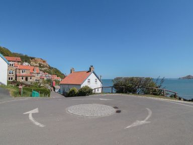 A street with houses and a sea view at Marigold Lodge Runswick Bay near Staithes