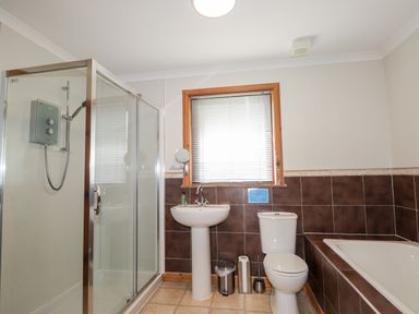A bathroom with a shower, sink, toilet, and bathtub at Lovat Highland Bothy in Beauly
