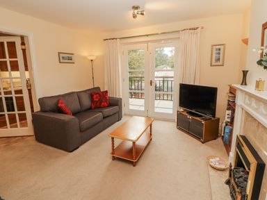 A living room with a sofa and coffee table at Flat 17 Keswick