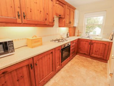 A kitchen with cabinets and appliances at Flat 17 in Keswick