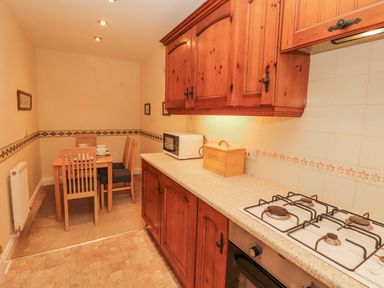 A kitchen with a dining table and chairs at Flat 17 in Keswick