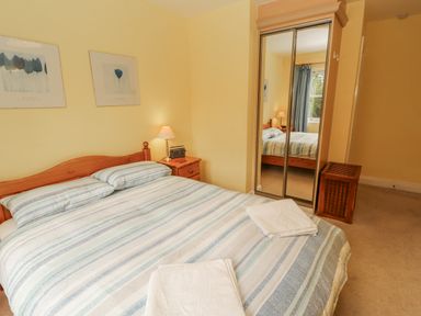 A bedroom with a bed and nightstand at Flat 17 in Keswick