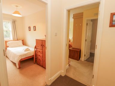 A bedroom with a bed and storage furniture at Flat 17 in Keswick
