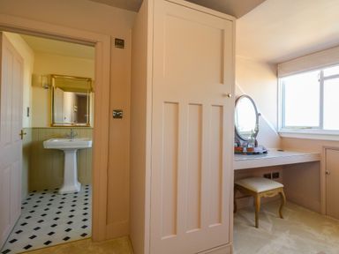 A bathroom with a sink and mirror at 123 On The Sea – The Eaves in Weymouth