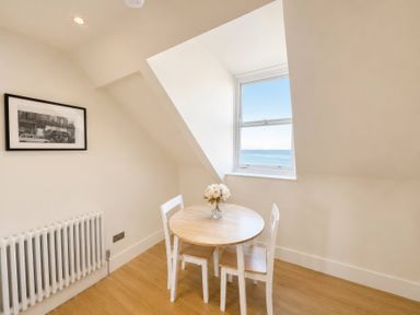 A dining area with a table and chairs at 123 On The Sea – The Eaves, Weymouth