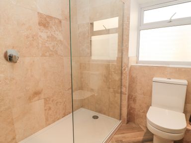 A bathroom with a walk in shower and a toilet at Mayfield Cottage in Nr Malmesbury