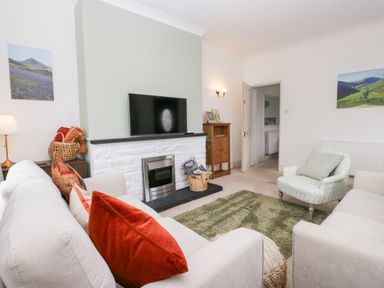 A living room with a sofa and television at 3 Nixon Terrace Broughton Moor near Maryport