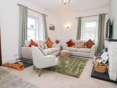 A living room with sofas and an armchair at 3 Nixon Terrace Broughton Moor near Maryport