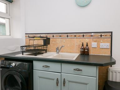 A kitchen with a sink and cabinets at 3 Nixon Terrace in Broughton Moor near Maryport
