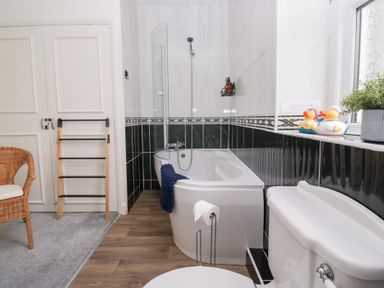 A bathroom with a bathtub, toilet, and rubber ducks at 3 Nixon Terrace Broughton Moor near Maryport
