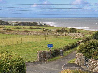 A coastal view with fields and a roadway at Tawelfan in Llwyngwril