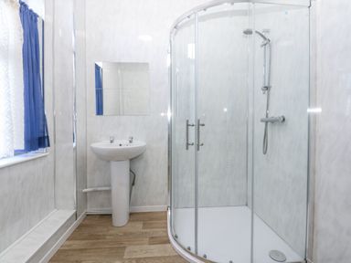 A bathroom with a shower and sink at Tawelfan in Llwyngwril
