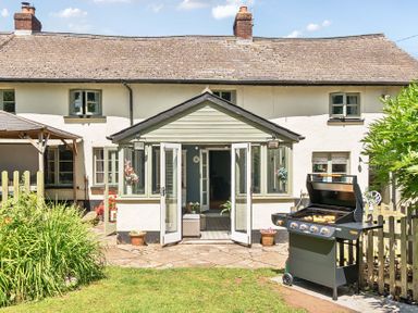 An outdoor patio with a grill at 2 Pigsfoot Cottages in Ash Thomas near Halberton, Devon
