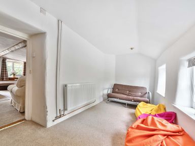 A living room with a sofa bed and bean bags at 2 Pigsfoot Cottages Ash Thomas near Halberton, Devon