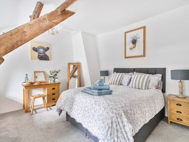 A bedroom with a bed and dressing table at 2 Pigsfoot Cottages Ash Thomas near Halberton, Devon