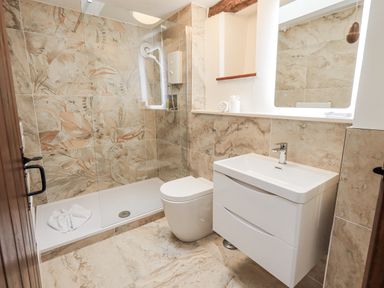 A bathroom with shower, toilet, and sink at Horse and Farrier Barn in Newton in Cartmel near Cartmel