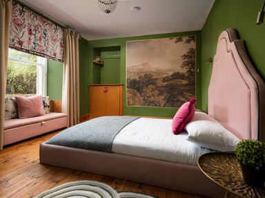 A bedroom with a bed and a bench at Wonderland in Tweedmouth, Berwick-Upon-Tweed