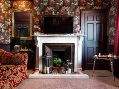 A sitting room with a fireplace and television at Wonderland in Tweedmouth, Berwick-Upon-Tweed