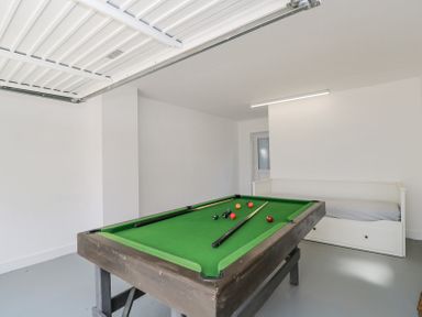 A game room with a pool table and a white daybed at Greystones in Upton St Leonards