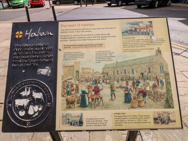 An informational sign about the history of Hexham including the market place and the church ruins with illustrations and text at Slaley Park Villa in Hexham
