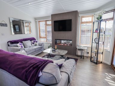 A living room with sofas and a coffee table at JacMar Lodge 14 Applethwaite, Limefitt Park near Windermere