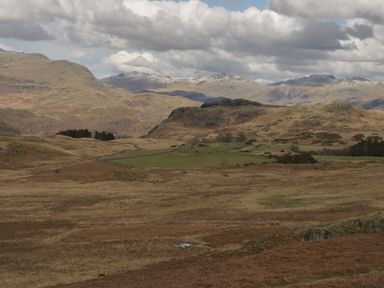 A vast open landscape with rolling hills and mountains under a cloudy sky at Dalegarth Hall Farm Cottage 1 Boot near Eskdale Green