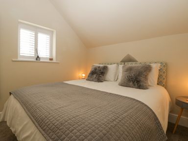 A bedroom with a bed with two gray pillows and a quilted blanket at The Old Chapel in Dorstone near Hay-on-Wye