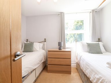 A bedroom with two single beds and a wooden chest of drawers between them at Fell View in Clappersgate near Ambleside