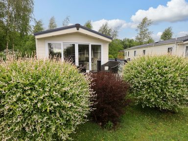 A cabin with large bushes in the outdoor area at 41, Grandma's Cottage South Lakeland Leisure Village near Carnforth