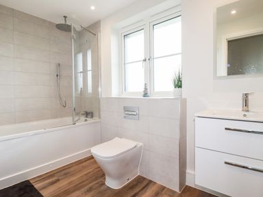 A bathroom with a bathtub shower combination toilet and sink at Chynoweth House in Cubert