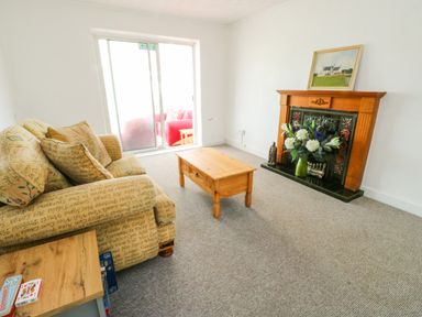 A living room with a sofa and coffee table at Pen Bonc Llanddaniel Near Gaerwen
