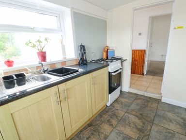 A kitchen with sink and stove at Pen Bonc in Llanddaniel Near Gaerwen