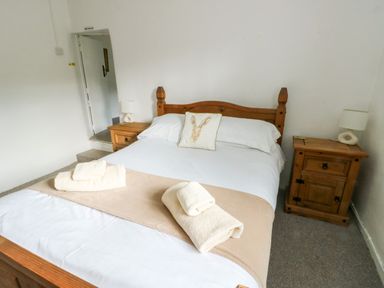 A bedroom with a bed and bedside tables at Pen Bonc in Llanddaniel Near Gaerwen
