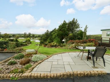 An outdoor area with a table and chairs at Pen Bonc Llanddaniel Near Gaerwen