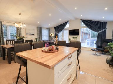 A dining area with a table and chairs at Unique Luxury Lodge 1 Langdale, White Cross Bay near Windermere