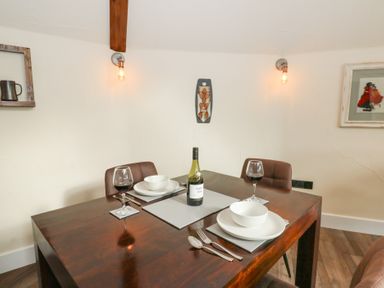 A dining room with a table set for two at Ty Crwn in Lampeter