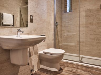 A bathroom with a sink toilet and glass shower enclosure at The Hayloft in Humshaugh