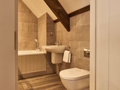 A bathroom with a bathtub a sink and a toilet at The Clocktower in Humshaugh