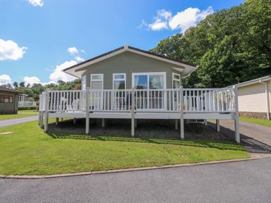A house with a deck and steps in front at Serenity in Kilgetty