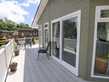 An outdoor seating area with chairs and planters at Serenity in Kilgetty