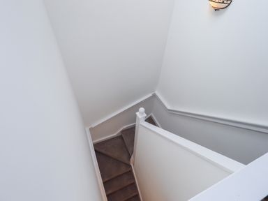 A staircase with a light fixture at Whitbarrow 24 in Penruddock