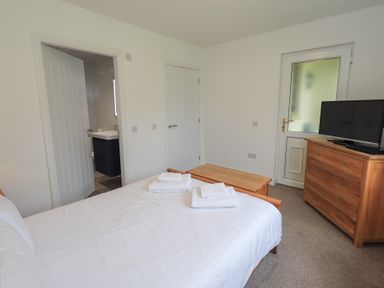 A bedroom with a bed and television at Whitbarrow 24 in Penruddock