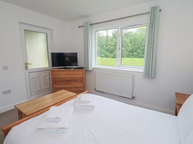 A bedroom with a bed and television at Whitbarrow 24 in Penruddock