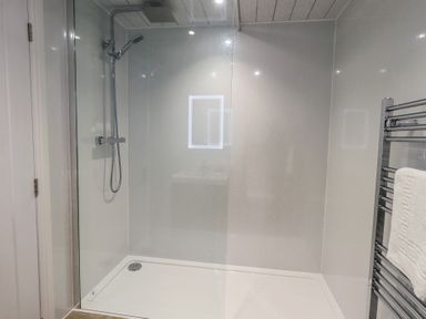 A shower with a glass enclosure in Whitbarrow 24 Penruddock
