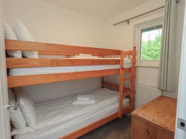 A bedroom with a bunk bed and a window at Whitbarrow 24 in Penruddock
