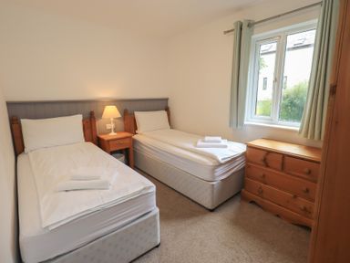 A bedroom with two beds and a window at Whitbarrow 24 Penruddock